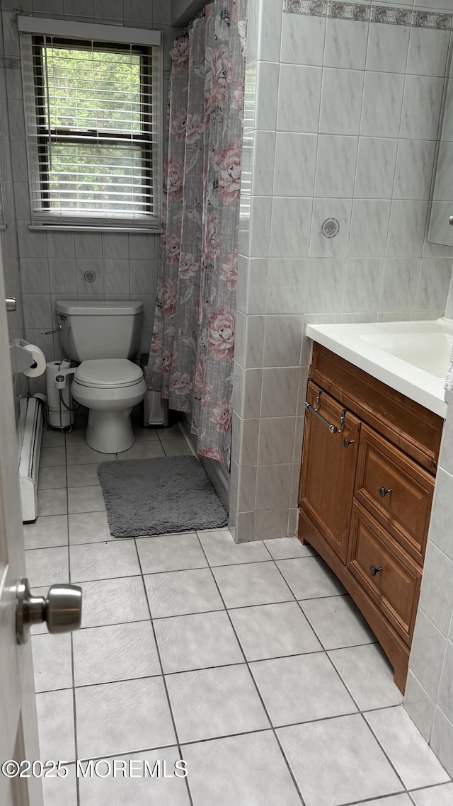 9 Longfellow Ter, Morganville, NJ 07751 - full bathroom featuring tile walls, vanity, tile patterned flooring, a baseboard heating unit, and a shower with shower curtain