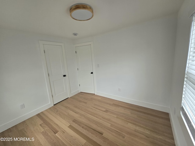 412 Ridge Ave, Neptune Township, NJ 07753 - empty room with healthy amount of natural light and light wood finished floors