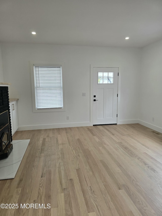 412 Ridge Ave, Neptune Township, NJ 07753 - foyer entrance featuring a wood stove, light wood finished floors, and recessed lighting