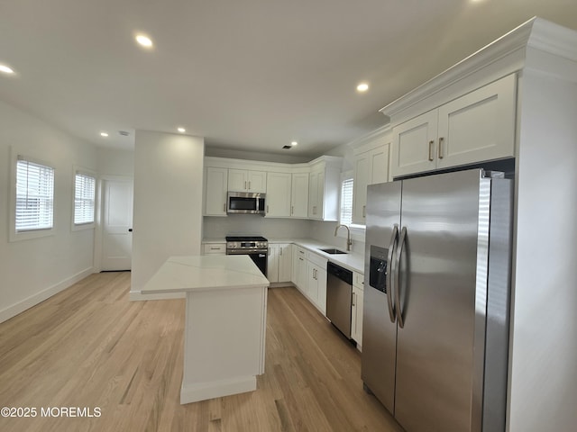 412 Ridge Ave, Neptune Township, NJ 07753 - kitchen featuring stainless steel appliances, healthy amount of natural light, recessed lighting, white cabinets, and light wood-type flooring