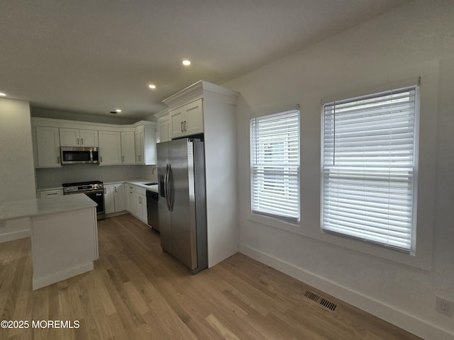 412 Ridge Ave, Neptune Township, NJ 07753 - kitchen with stainless steel appliances, light wood-style floors, white cabinetry, recessed lighting, and light countertops