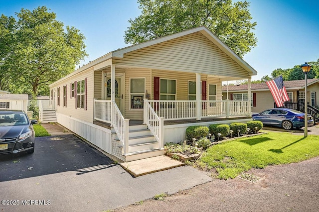 14 Village Rd, Morganville, NJ 07751 - view of front of home featuring a porch and a front yard