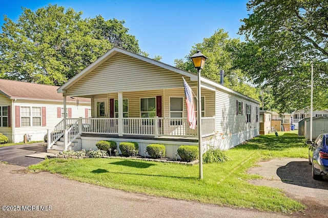 14 Village Rd, Morganville, NJ 07751 - view of front facade with covered porch and a front yard