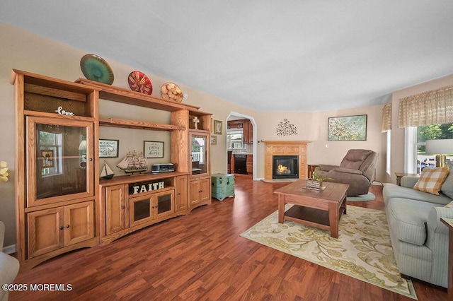 14 Village Rd, Morganville, NJ 07751 - living area with dark wood-style floors, arched walkways, and a fireplace with flush hearth
