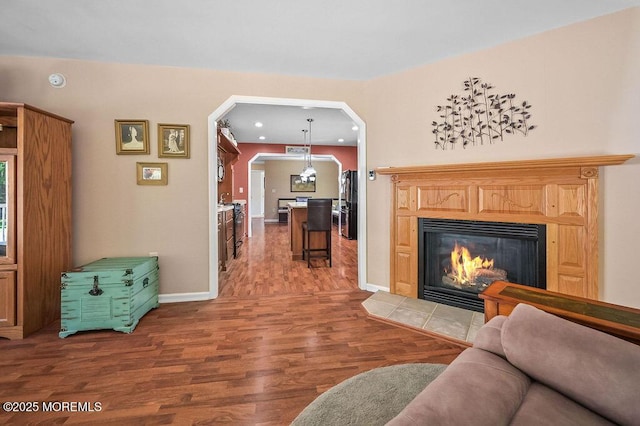 14 Village Rd, Morganville, NJ 07751 - living area with wood finished floors, arched walkways, a tile fireplace, and recessed lighting