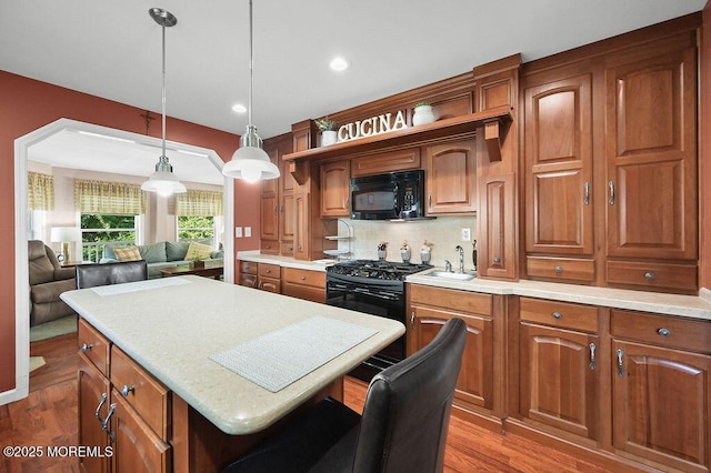 14 Village Rd, Morganville, NJ 07751 - kitchen with black appliances, light countertops, brown cabinetry, and recessed lighting