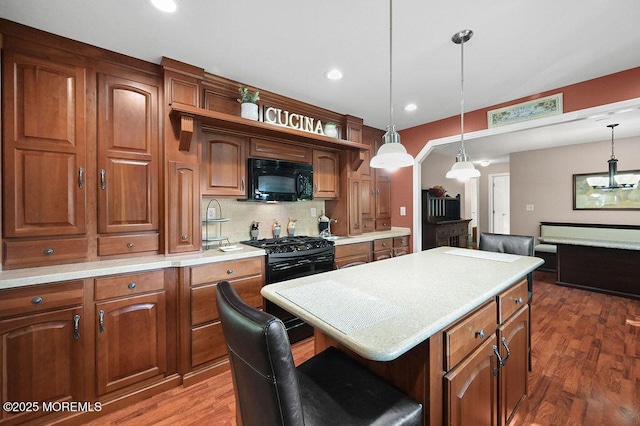 14 Village Rd, Morganville, NJ 07751 - kitchen featuring black appliances, light countertops, dark wood finished floors, backsplash, and pendant lighting