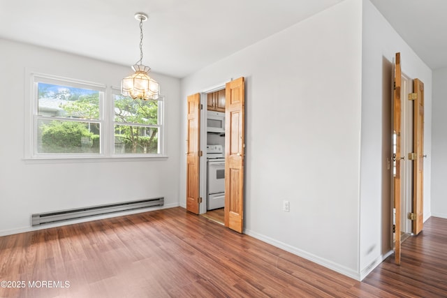 41 Falmouth Ave Unit 72, Whiting, NJ 08759 - unfurnished dining area featuring a baseboard radiator, a chandelier, and wood finished floors