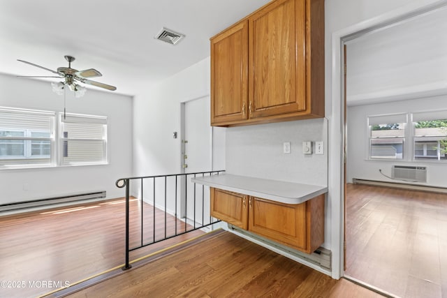 41 Falmouth Ave Unit 72, Whiting, NJ 08759 - kitchen featuring a baseboard radiator, brown cabinets, wood finished floors, and ceiling fan