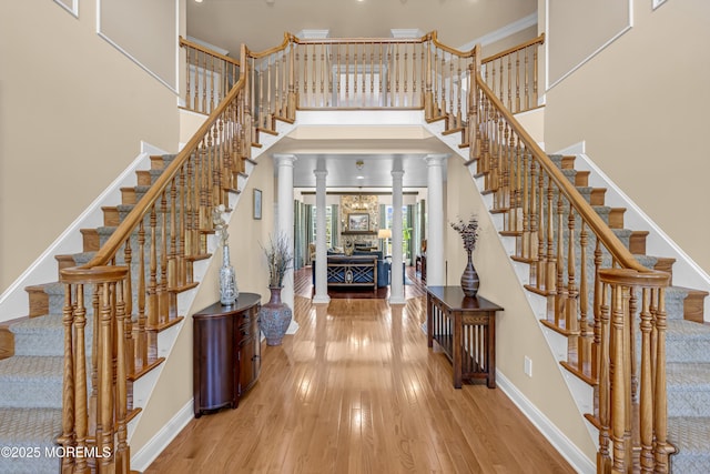4 Geraldine Ct, Farmingdale, NJ 07727 - stairs with wood finished floors, a high ceiling, and decorative columns