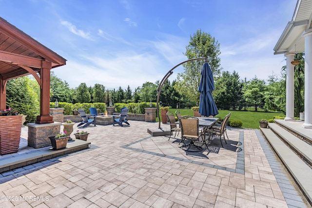 4 Geraldine Ct, Farmingdale, NJ 07727 - view of patio with a fire pit, outdoor dining space, and view of wooded area
