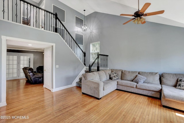 8 Shadow Ridge Ct, Howell, NJ 07731 - living room featuring wood-type flooring, high vaulted ceiling, stairs, a ceiling fan, and a chandelier