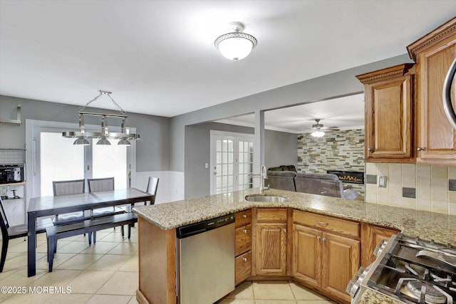 8 Shadow Ridge Ct, Howell, NJ 07731 - kitchen featuring stainless steel dishwasher, a ceiling fan, a fireplace, backsplash, and a wainscoted wall