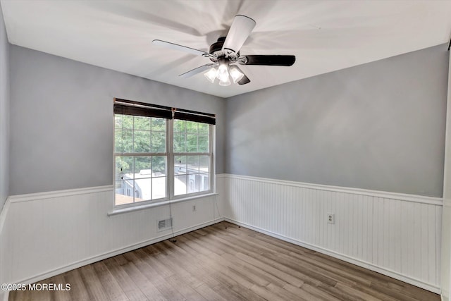 8 Shadow Ridge Ct, Howell, NJ 07731 - empty room with wainscoting, wood finished floors, and a ceiling fan