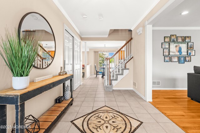 51 Davids Ln, Howell, NJ 07731 - entrance foyer with light tile patterned floors, ornamental molding, stairway, a chandelier, and recessed lighting