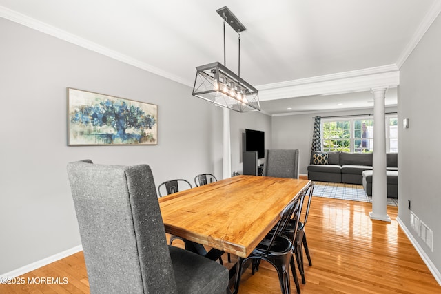 51 Davids Ln, Howell, NJ 07731 - dining space with decorative columns, crown molding, and light wood finished floors