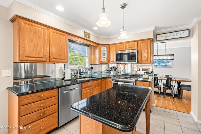 51 Davids Ln, Howell, NJ 07731 - kitchen with stainless steel appliances, light tile patterned floors, crown molding, dark stone counters, and hanging light fixtures