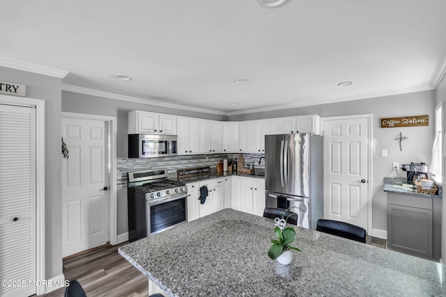 37 Kennedy Way, Keansburg, NJ 07734 - kitchen with appliances with stainless steel finishes, light stone counters, ornamental molding, wood finished floors, and recessed lighting