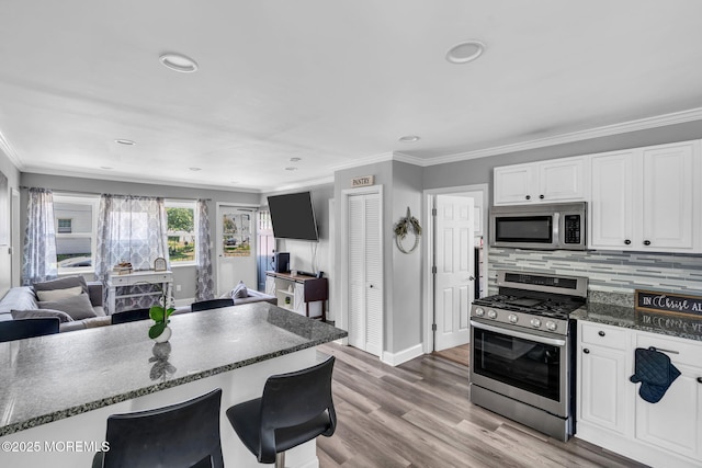 37 Kennedy Way, Keansburg, NJ 07734 - kitchen featuring appliances with stainless steel finishes, white cabinetry, open floor plan, crown molding, and recessed lighting