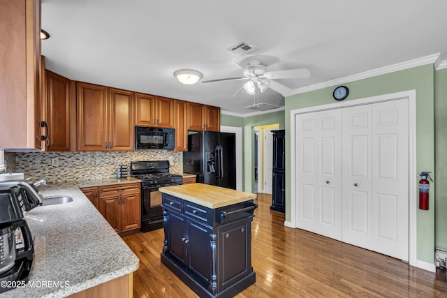 3 Redlands Ct, Toms River, NJ 08757 - kitchen with black appliances, decorative backsplash, ornamental molding, ceiling fan, and wood finished floors