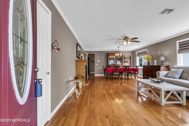 3 Redlands Ct, Toms River, NJ 08757 - living area with crown molding, light wood-style flooring, a ceiling fan, a chandelier, and a baseboard radiator