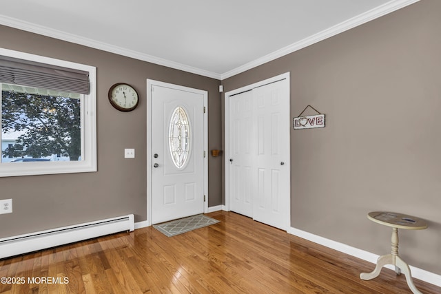3 Redlands Ct, Toms River, NJ 08757 - entrance foyer featuring wood finished floors, a baseboard heating unit, and ornamental molding