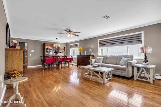 3 Redlands Ct, Toms River, NJ 08757 - living area with light wood-type flooring, ornamental molding, ceiling fan, a chandelier, and baseboard heating