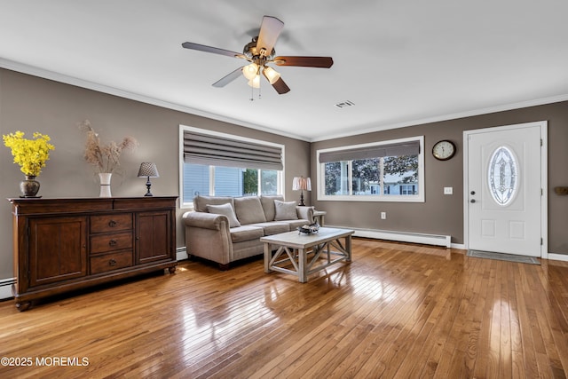 3 Redlands Ct, Toms River, NJ 08757 - living area featuring baseboard heating, a ceiling fan, light wood-style floors, and ornamental molding