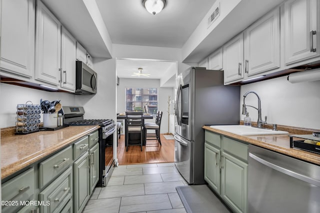 193 Sierra Ct, Woodbridge, NJ 07095 - kitchen with appliances with stainless steel finishes, green cabinets, ceiling fan, and white cabinets