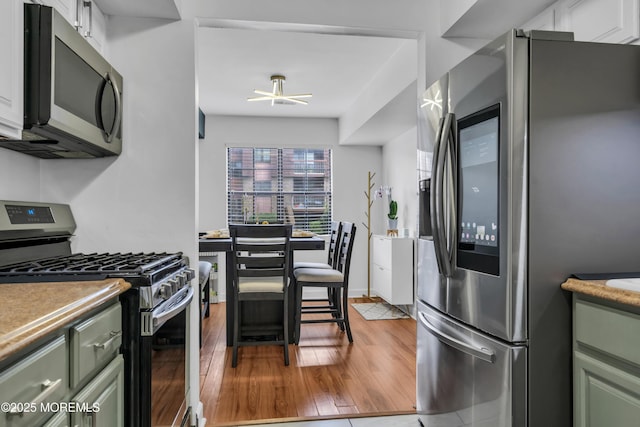 193 Sierra Ct, Woodbridge, NJ 07095 - kitchen featuring stainless steel appliances, green cabinetry, and wood finished floors