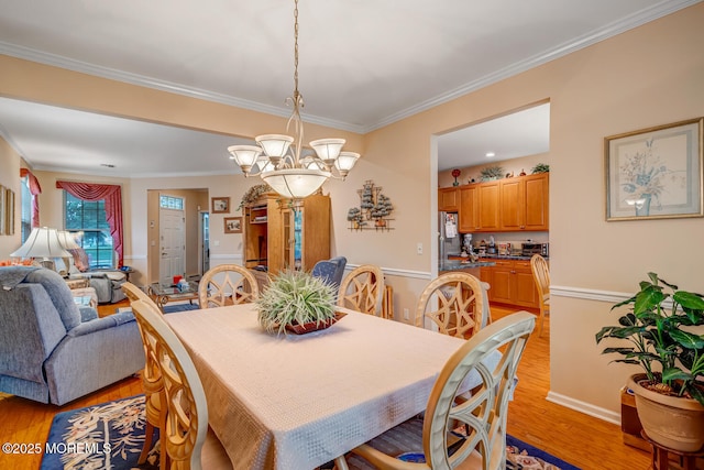 41 Sunrise Bay Blvd, Little Egg Harbor, NJ 08087 - dining area with a chandelier, light wood-type flooring, and crown molding