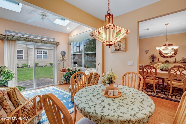 41 Sunrise Bay Blvd, Little Egg Harbor, NJ 08087 - dining room featuring a skylight, a chandelier, light wood-style flooring, vaulted ceiling, and ceiling fan