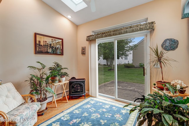 41 Sunrise Bay Blvd, Little Egg Harbor, NJ 08087 - entryway with a baseboard radiator, a skylight, a wood stove, wood finished floors, and vaulted ceiling