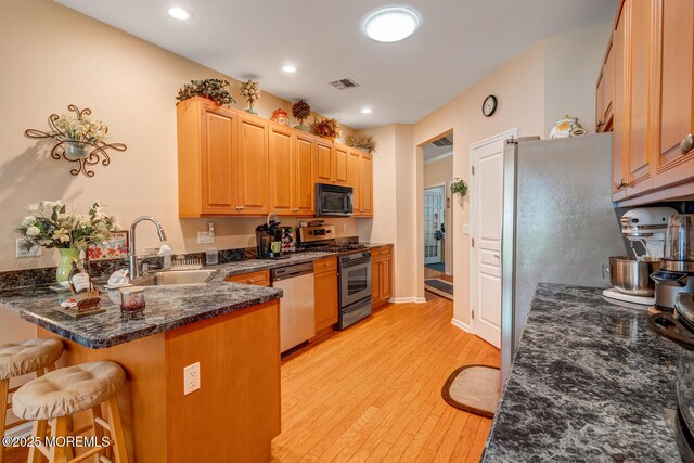 41 Sunrise Bay Blvd, Little Egg Harbor, NJ 08087 - kitchen with appliances with stainless steel finishes, a peninsula, light wood finished floors, a breakfast bar, and recessed lighting