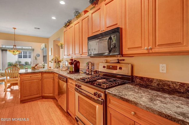 41 Sunrise Bay Blvd, Little Egg Harbor, NJ 08087 - kitchen with appliances with stainless steel finishes, light wood-style flooring, recessed lighting, dark stone counters, and a peninsula