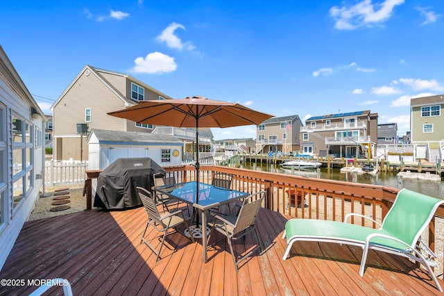 8 Ralph Ln, Beach Haven West, NJ 08050 - wooden terrace featuring a grill, outdoor dining space, a water view, and a shed