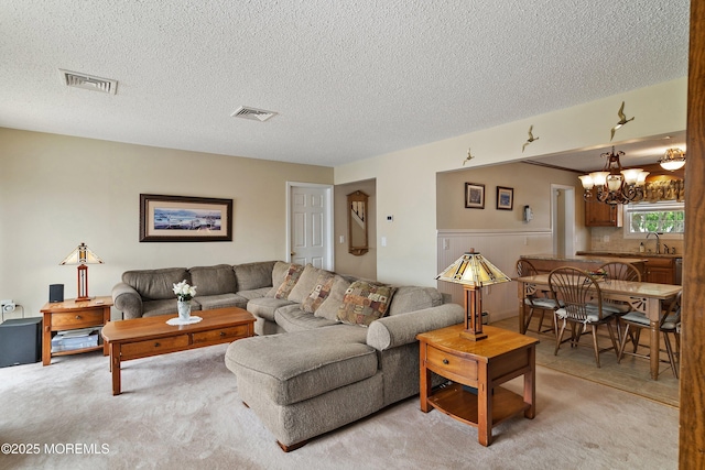 54 Storm Jib Ct, Bayville, NJ 08721 - living room featuring a chandelier, light colored carpet, and a textured ceiling