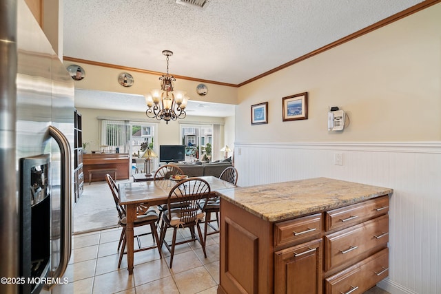 54 Storm Jib Ct, Bayville, NJ 08721 - dining area featuring a textured ceiling, a chandelier, wainscoting, light tile patterned floors, and ornamental molding