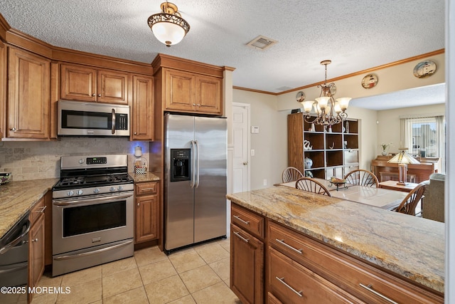 54 Storm Jib Ct, Bayville, NJ 08721 - kitchen featuring stainless steel appliances, brown cabinetry, a chandelier, ornamental molding, and backsplash