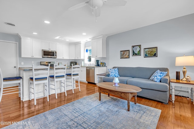 23 Auburn Rd, Toms River, NJ 08757 - living area with ceiling fan, light wood-style floors, recessed lighting, and a baseboard heating unit