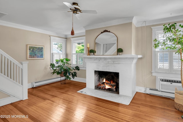 340 Main Ave, Bay Head, NJ 08742 - unfurnished living room featuring a baseboard radiator, a fireplace, wood-type flooring, a ceiling fan, and ornamental molding