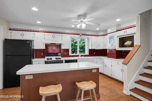 340 Main Ave, Bay Head, NJ 08742 - kitchen with freestanding refrigerator, white range with gas cooktop, under cabinet range hood, light countertops, and recessed lighting