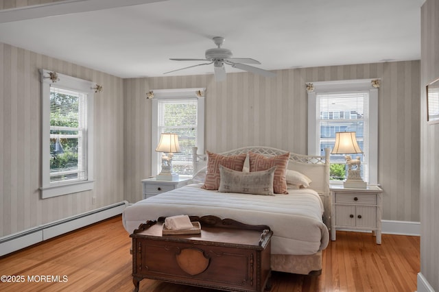 340 Main Ave, Bay Head, NJ 08742 - bedroom with wallpapered walls, baseboard heating, wood finished floors, and ceiling fan
