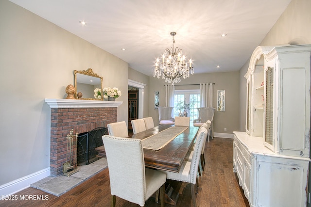 74 Squankum Rd, Tinton Falls, NJ 07724 - dining space with dark wood-style flooring, a chandelier, a brick fireplace, and recessed lighting