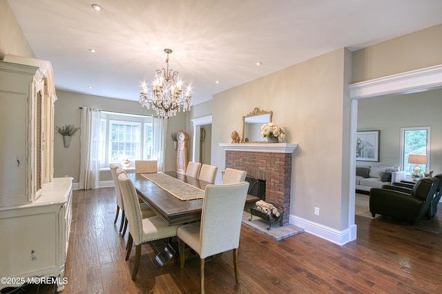 74 Squankum Rd, Tinton Falls, NJ 07724 - dining room with dark wood-style floors, a chandelier, recessed lighting, and a fireplace
