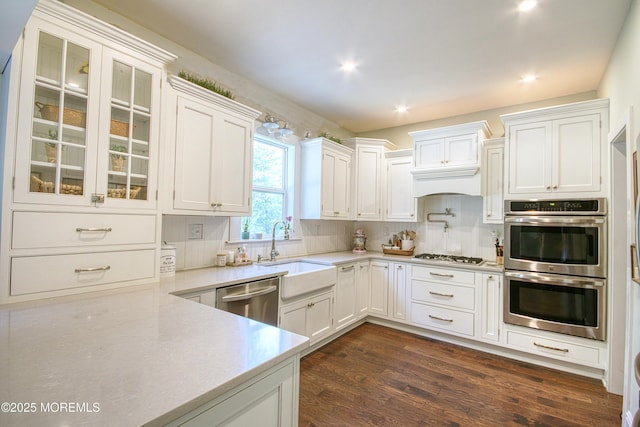 74 Squankum Rd, Tinton Falls, NJ 07724 - kitchen with stainless steel appliances, light countertops, white cabinets, backsplash, and recessed lighting