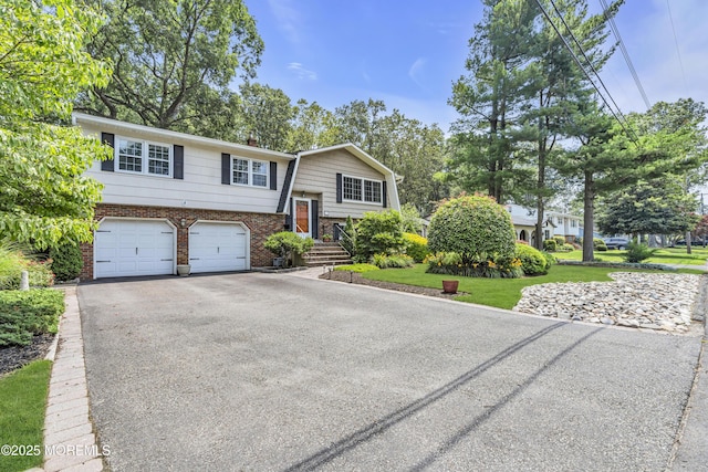 27 Greenhill Dr, Brick, NJ 08724 - split foyer home featuring asphalt driveway, a garage, and brick siding