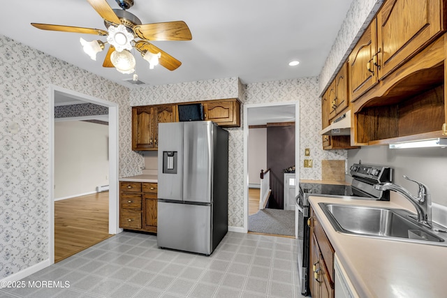 27 Greenhill Dr, Brick, NJ 08724 - kitchen with appliances with stainless steel finishes, wallpapered walls, under cabinet range hood, ceiling fan, and brown cabinetry