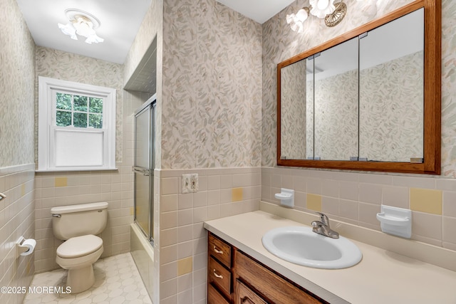 27 Greenhill Dr, Brick, NJ 08724 - bathroom with tile walls, wallpapered walls, vanity, a wainscoted wall, and enclosed tub / shower combo