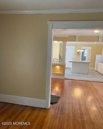 1604 Bangs Ave, Asbury Park, NJ 07712 - unfurnished living room featuring light wood-style flooring, ornamental molding, and a chandelier